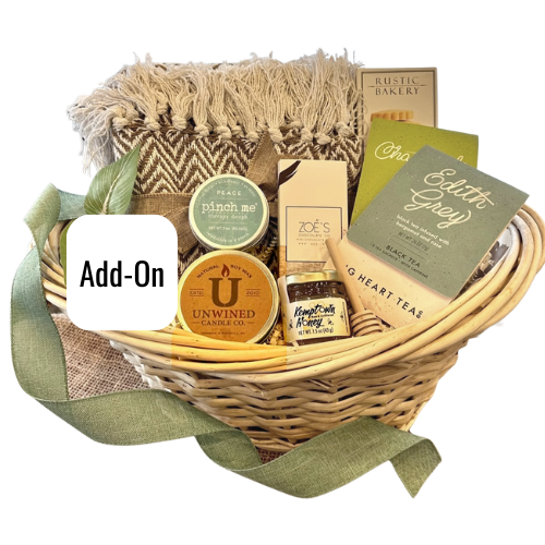 Sending comfort with this thinking of you arrangement. Fitting for anyone who needs a little TLC. Includes a cotton hand woven throw blanket 50''x60'', assorted teas, honey with wand, chocolates and shortbread cookies. Pinch Me Therapy Dough and an Unwined Candle. Select a unique add-on fitting the occasion.  Your gift will be wrapped in a clear cello with a thoughtful tie bow.