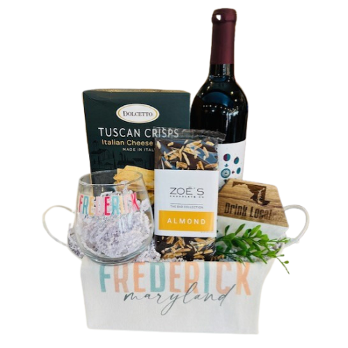 Welcome to Frederick Wine Gift perfect for a new home owner and someone new to the area.  Includes a bottle of Mazzaroth Vineyard wine, cheese crackers, Frederick wine glass, Zoe's Chocolate bar, Drink Local wooden/ceramic coaster and a Frederick themed hand towel. Your gift will be wrapped in a clear cello with a festive tie bow.