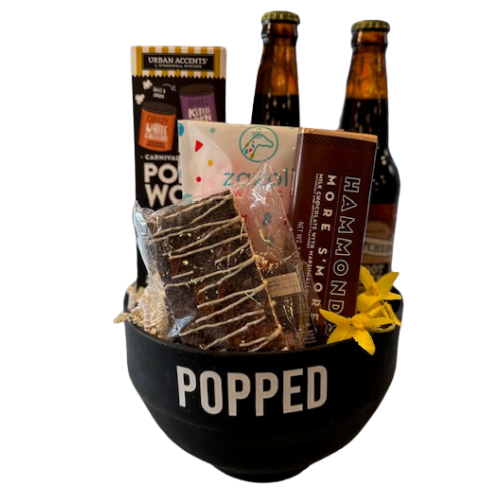 All you need for a fun movie night in.  Your gift created in a ready to use - silicone popper bowl, 2 Old Fashioned Sodas, Pop n Wow Popcorn with 2 seasoning packets, Assorted movie candy favorites, gummies, chocolate bar and marshmallow treats. Your gift will be wrapped in a clear cello with a festive tie bow.