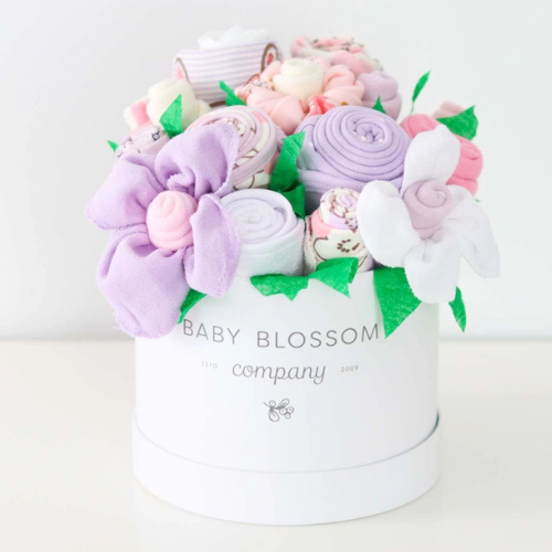 Celebrate the new mom or mom-to-be in the best way possible with flowers that are practical and oh-so-adorable. The blooms: 1 bodysuit 1 bib 1 burp cloth 3 washcloths 3 pairs of socks, Sized 0-3months. Available in 3 unique collections - Neutral Baby Animals, Pink Ballerina, Blue Fox
